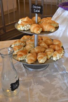 three tiered trays filled with pastries on top of a table