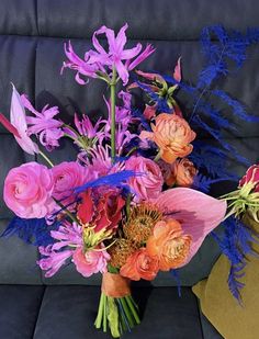 a bouquet of flowers sitting on top of a couch