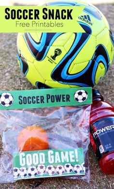 a soccer ball sitting on top of a field next to a plastic bag with good game stickers