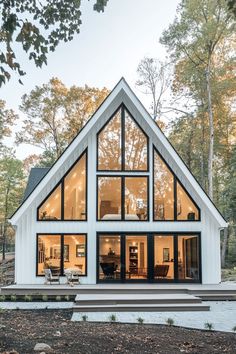 a large white and black house with lots of windows