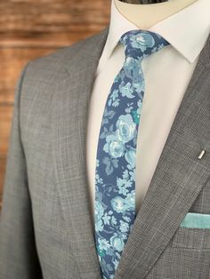 This handmade floral tie is an excellent accessory for weddings, parties, proms - an excellent gift for anyone who enjoys dressing-up dapper! Style: Slim/narrow Fabric: 100% cotton Approx. Measurements: (W) 2.4 in. x (L) 58 in. Care: Dry clean only Matching Men's Bow Tie Style: Pre-tied (w/ adjustable straps) Fabric: 100% brushed cotton Size: Mens | One size Bow measures approx. 4.75 in. x 2.4 in. Care: Dry clean only Matching Pocket Square Fabric: 100% brushed cotton Approx. 12 in. x 12 in. Dry Square Fabric, Groomsman Gift, Dapper Style, Tie Styles, Mens Bow Ties, Blue Floral Print, Party Style, Fabric Squares, Grey Floral