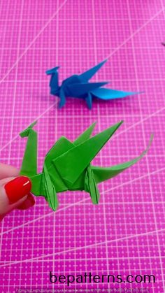 origami birds on pink background with text overlay that says how to make an origami bird