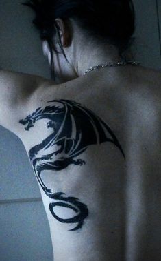 a woman with a dragon tattoo on her back