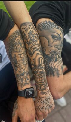 two people with tattoos on their arms