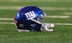 a football helmet sitting on top of a field