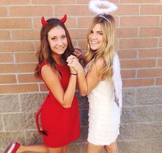 two girls dressed in devil costumes posing for the camera