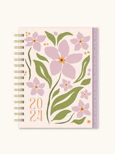 a spiral notebook with pink flowers and green leaves on the cover, which reads oss as