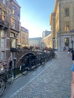 several bicycles are parked along the side of a canal