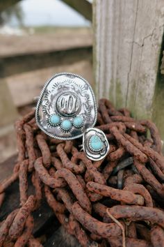 Saddle up with The Cowboy Hat Ring. This unique ring features a classic cowboy hat design and a stunning turquoise stone. Plus, it's fully adjustable for the perfect fit. Giddy up and add some western charm to any look with this statement piece. Cowboy Hat Ring, Cowboy Hat Design, Classic Cowboy, Country Kids, The Cowboy, Hat Design, Cowboy And Cowgirl, Unique Ring, Cowboy Hat