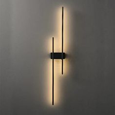 a wall mounted light that is on the side of a wall with two lights attached to it