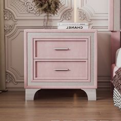 a pink nightstand next to a bed in a room