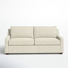 a white couch sitting on top of a white floor