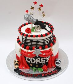 a birthday cake decorated with red, white and black decorations