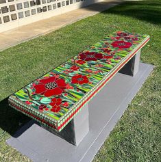 a bench made out of glass sitting on top of a cement slab in front of a building