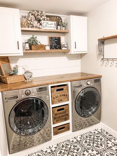 a washer and dryer sitting in a room next to each other on top of cabinets