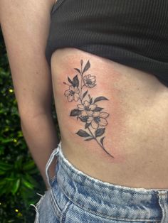 a woman with a flower tattoo on her stomach