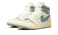 The Women’s Air Jordan 1 High MM “Jade Smoke” is a women’s-exclusive shoe that modifies the classic basketball silhouette with layered panels.  The Jordan 1 High MM is made from a combination of leather and canvas, and features layered overlays for a contemporary spin.  On the “Jade Smoke” colorway, the shoe features a Jade Smoke perforated leather paired with cream-colored raised leather panels on the toe, forefoot, and eyelets.  White canvas can be found on the mid-panel and collar, while a ra Womens Air Jordan 1, Basketball Silhouette, Exclusive Shoes, Leather And Canvas, Stadium Goods, Perforated Leather, Retro Look