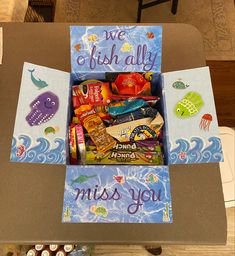 a box filled with lots of candy sitting on top of a table