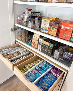 an organized pantry with lots of food and snacks in the bins on the bottom shelf