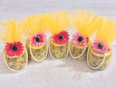 three yellow vases with pink flowers in them and the word love spelled on top