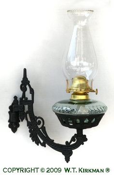 an old fashioned wall light with a glass shade