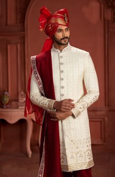 Embark on a journey of sophistication and grace with our exclusive ensemble: a cream sherwani paired with a red turban, a fusion that epitomizes timeless charm and elegance. Meticulously crafted from luxurious fabrics like silk or brocade, the cream sherwani exudes refined opulence with its intricate detailing and understated allure. Adorned with delicate embroidery or embellishments, it promises to command attention at any grand occasion, from weddings to cultural celebrations. Complementing th Cream Sherwani, Red Turban, Weddings Receptions, Saree Gown, Cultural Celebration, Sequence Work, Eid Collection, Intricate Embroidery, The Cream