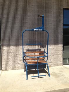 a wooden bench sitting in front of a building