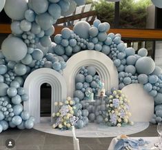 a room filled with blue and white balloons