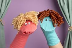 two hand puppets that look like people with dreadlocks