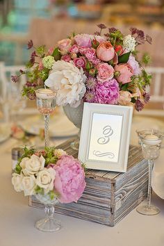 a table with flowers and wine glasses on it