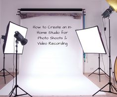 a photo studio with lighting equipment and video recording equipment in front of the white backdrop