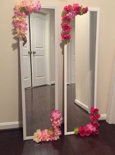 two mirrors with flowers on them in a room