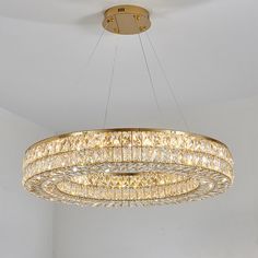 a chandelier hanging from the ceiling in a room with white walls and flooring