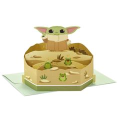 a pop up card with an image of baby yoda sitting in the middle of a desert