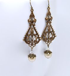 "These beautiful handmade earrings feature highly detailed Victorian style antiqued brass filigree paired with luminous champagne glass pearls topped with clear Swarovski crystal beads. Created with the elegance of old Victorian beauty. Dramatic yet lightweight stamping make these lovely earrings easy to wear. Earrings measure approximately 2 11/16\" long end to end (from top of ear wire to base of bead). Solid antique brass french hook wires are beautifully aged and are lead and nickel free. Pl Bird Eyes, Beadwork Ideas, Mood Jewelry, Earring Inspiration, Dr Closet, Victorian Earrings, Vintage Weddings, Earrings Art, Trendy Nail