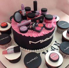 a cake with cupcakes and makeup on it