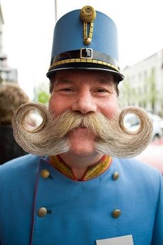 a man in uniform with a fake moustache on his face and mustaches