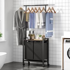 an image of a bathroom setting with clothes hanging on the rack and washer next to it