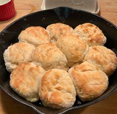 a pan filled with biscuits sitting on top of a wooden table