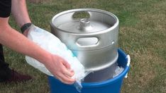 a man is cleaning the bottom of a metal barrel