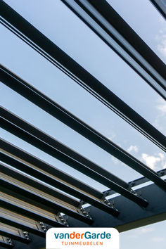 an image of the inside of a building with metal bars and sky in the background