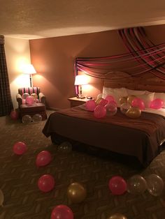 balloons are floating in the air on a bed