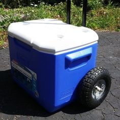 a blue and white cooler sitting on top of a sidewalk