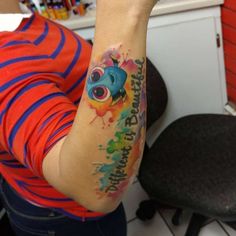 a woman with a colorful tattoo on her arm