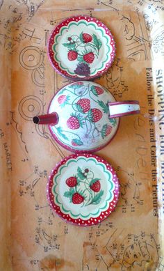 two plates with strawberries painted on them