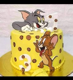 a yellow cake with cartoon characters on it