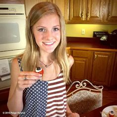 a young woman is holding an american flag bag