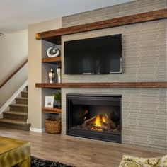 a living room filled with furniture and a fire place in front of a flat screen tv