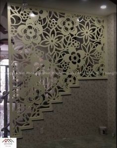 the stair case is decorated with intricate laser cutouts and decorative wall paper for privacy