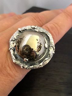 ARTISAN AMMONITE FOSSIL RING Hand-made Sterling Silver. Size 10 Stones used: Ammonite-Fossil Face of the ring: Height - 35mm, Width-35mm Height - 1 3/8', Width - 1 3/8' Band height - 12-9mm Please note: Colors may vary slightly due to monitor display settings. Items in the photograph are not actual size. Closeup photos are taken. Please read the measurements. Thank you for visiting! PLEASE VISIT MY OTHER SHOP FOR UNIQUE HANDCRAFTED ARTISAN JEWELRY https://www.etsy.com/shop/AlenaZenaJewelry or ju Unique Dome Ring With Polished Finish For Promise, Unique Polished Open Ring, Unique Open Ring With Polished Finish, Gift Dome Ring With Polished Finish, Unique Dome Promise Ring With Polished Finish, Sterling Silver Concave Dome Ring As Gift, Unique Hand Forged Engraved Promise Ring, Unique Polished Promise Ring, Unique Promise Ring With Polished Finish